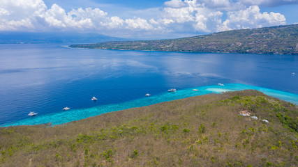 Aerial view of the Sumilon island, sandy beach with tourists swimming in beautiful clear sea water of the Sumilon island beach, Oslob, Cebu, Philippines.