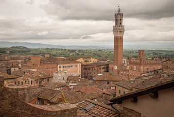 Obraz premium Scenery of Siena, a beautiful medieval town in Tuscany, view from the Dome & Bell Tower of Siena Cathedral (Duomo di Siena), landmark Mangia Tower in Piazza del Campo