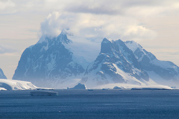 Snow-capped mountains and frozen coasts of the Antarctic Peninsula, Palmer Archipelago, Antarctica