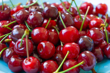 Red sweet cherry on a plate