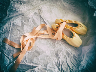 The abstract art design background of ballet shoe put on grunge surface background,classic old film...