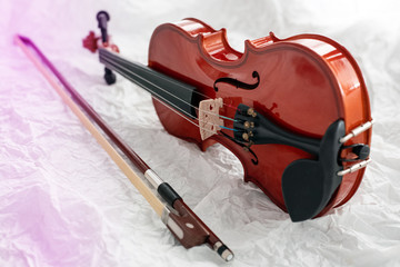 Fototapeta na wymiar The wooden violin put on grunge surface background