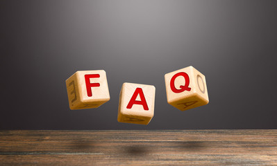 Wooden blocks make word abbreviation FAQ (frequently asked questions). Convenient form of answers...