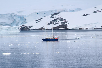 A ship at the abandoned British base at Port Lockroy,  now a museum and post office, on the north-western shore of Wiencke Island, Palmer Archipelago, Antarctica
