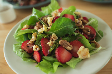 salad with strawberry spinach leaves and feta cheese