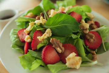 salad with strawberry spinach leaves and feta cheese