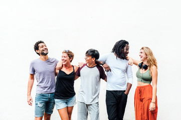 Portrait of a group of five happy friends in the street. Friendship concept