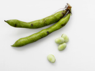 green beans in pods on a white background