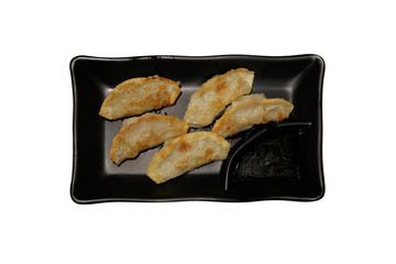 Plate of asian gyoza, dumplings snack with soy sauce.