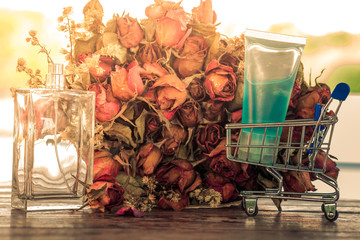 Fototapeta na wymiar background view of a clear bottle containing perfume placed near a bouquet of roses on the table, business concept selling products or cosmetic products
