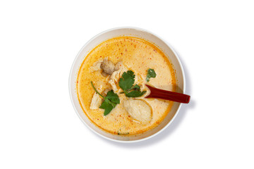Top View of Tom Ka Chicken Soup, Thai Spicy Soup  with Coconut Milk, galangal, Mushroom, lemongrass, cilantro on White Background. Thai Food. Clipping Path on the Main Object (not the shadow) Included