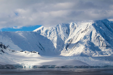 Naklejka na ściany i meble Snow-capped mountains and frozen coasts of the Antarctic Peninsula, Palmer Archipelago, Antarctica