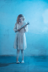 scary girl in white dress from horror film in  room