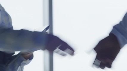 Close up shot of handshaking of businesswoman and her male colleague