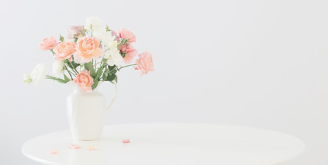 beautiful roses in ceramic white jug