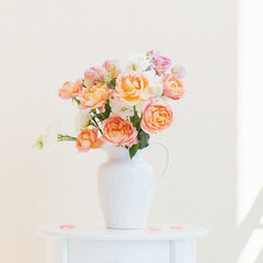 beautiful roses in ceramic white jug
