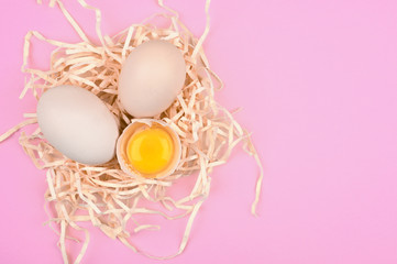 natural eggs on a pink background. minimalistic trend, top view. Egg tray. Easter concept.