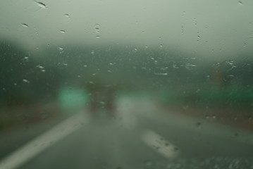 Blurred image running on highway on rainy day