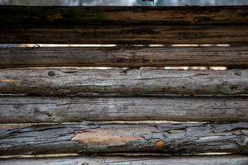 Obraz premium An old village fence or animal pen made of gray wooden beams. Retro