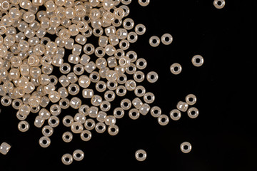 White pearls on the black background. Composition of different shaped natural fresh water pearls.