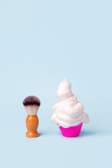 Wooden classic shaving brush with foam in cupcake, Treatment for bodycare, funny concept of hair remove, minimal creative idea for barbershop, banner, summer vacation preparing