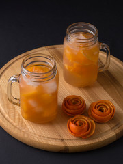 orange juice with ice on the kitchen table.