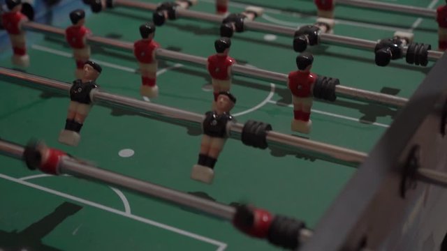 Play table football soccer game red and black players foosball closeup slow motion camera movement