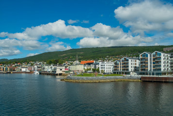 Molde, Norway - july 2019. Modern architecture on the background of Scandinavian mountains and blue sky. Sunny day in Molde, Norway.