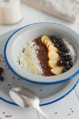 Semolina porridge with apples and currants for breakfast on a white background