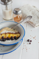 Semolina porridge with apples and currants for breakfast on a white background