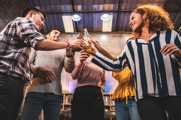 corporate, celebration and holidays concept - happy friends or team with party accessories taking selfie at office.business team eating wine  at the loft office party.