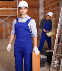 Two builders in work wear