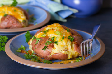 Twice Baked Potatoes with Bacon, Cheese and  Scallion. Potato in jacket. Horizontal image