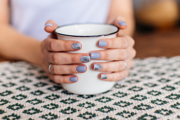 Girl hands and cup of tea.