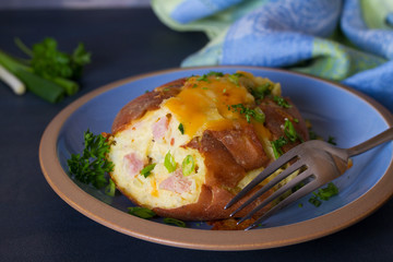 Twice Baked Potatoes with Bacon, Cheese and  Scallion. Potato in jacket. Horizontal image