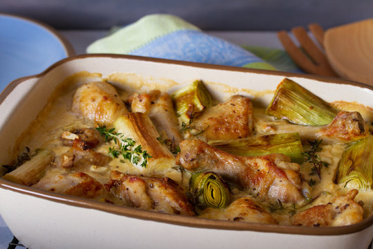 Chicken thighs and legs in sour cream sauce with leek and thyme. Horizontal image