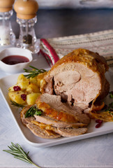 Roast turkey leg. Boned and rolled turkey leg with potatoes and cranberries