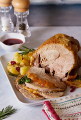 Roast turkey leg. Boned and rolled turkey leg with potatoes and cranberries