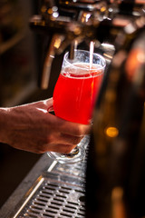 bartender pouring craft beer in to the glass