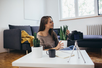 woman video blogger making video from her home