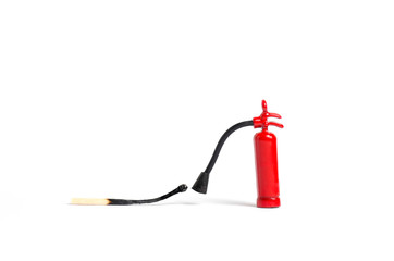 Micro fire extinguisher close to a burnt match against a white background, macro shot