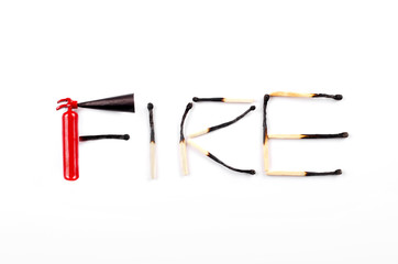 Word fire made of burnt matches and a tiny fire extinguisher