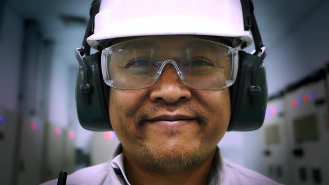 Portrait Of Worker Man Wearing A Safety Helmet And Safety Goggles Stay In Petroleum Refinery Plant