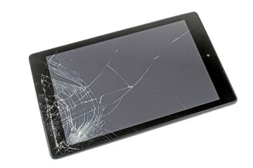 A computer tablet with a smashed display screen on a white background