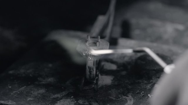 Man crafting a diamond ring jewel with his tools 