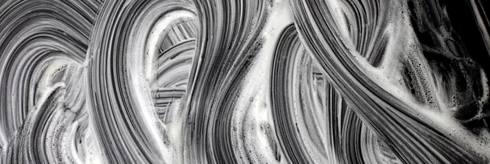 Selbstklebende Fototapeten Foamy wawe stains on black surface. Abstract texture grunge background. © Liliia