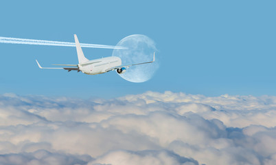 Naklejka na ściany i meble White passenger airplane in the clouds on the background trail of white smoke from the airplane on blue sky - Travel by air transport Elements of this image furnished by NASA