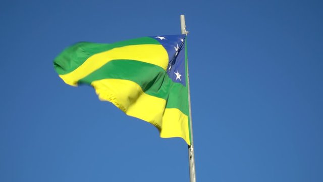 Beautiful flag of Sergipe state waving in the wind on sunny summer day with blue sky. Concept of state, symbol, republic, Brazil, cultural identity, democracy, geography and politics.