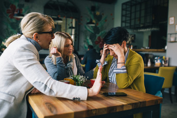 women consoling their friend