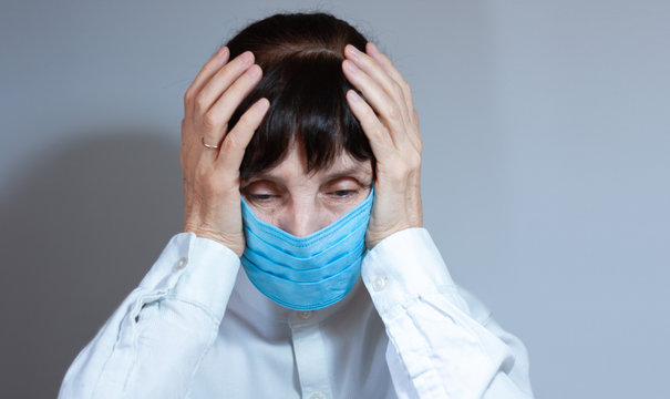 Coronavirus quarantine and Air pollution pm2.5 concept. Sick sad depressed, thoughtful old woman wearing respirator mask for protect. Wuhan, China epidemic virus symptoms background.